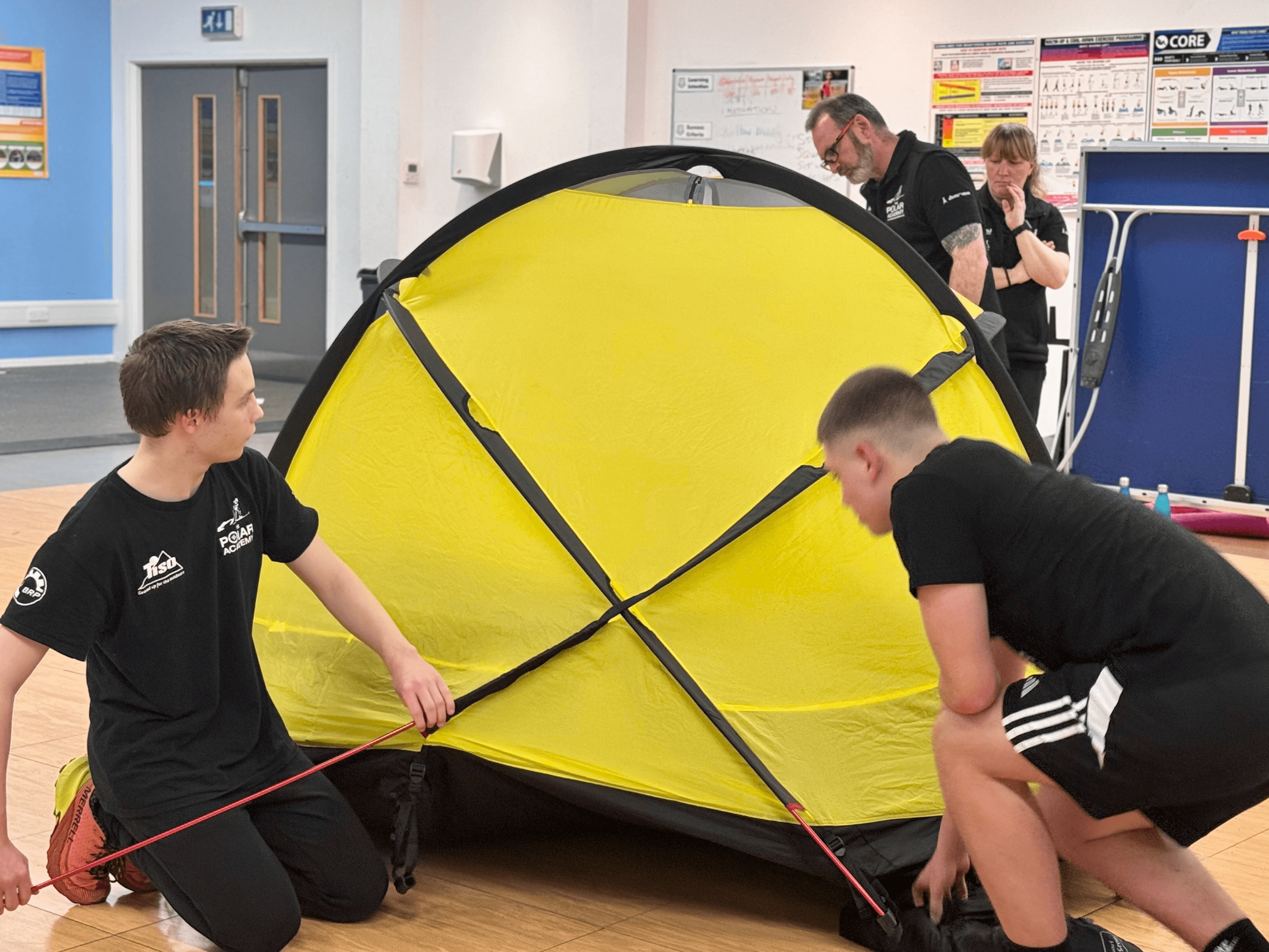 The boys of Park Mains practice setting uo camp under Craig's watchful eye